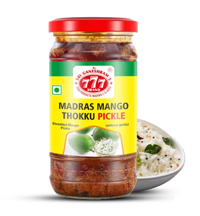 Authentic Madras Mango Pickle in a jar, made with fresh raw mangoes, aromatic spices, and oil for a bold, tangy, and spicy flavor.